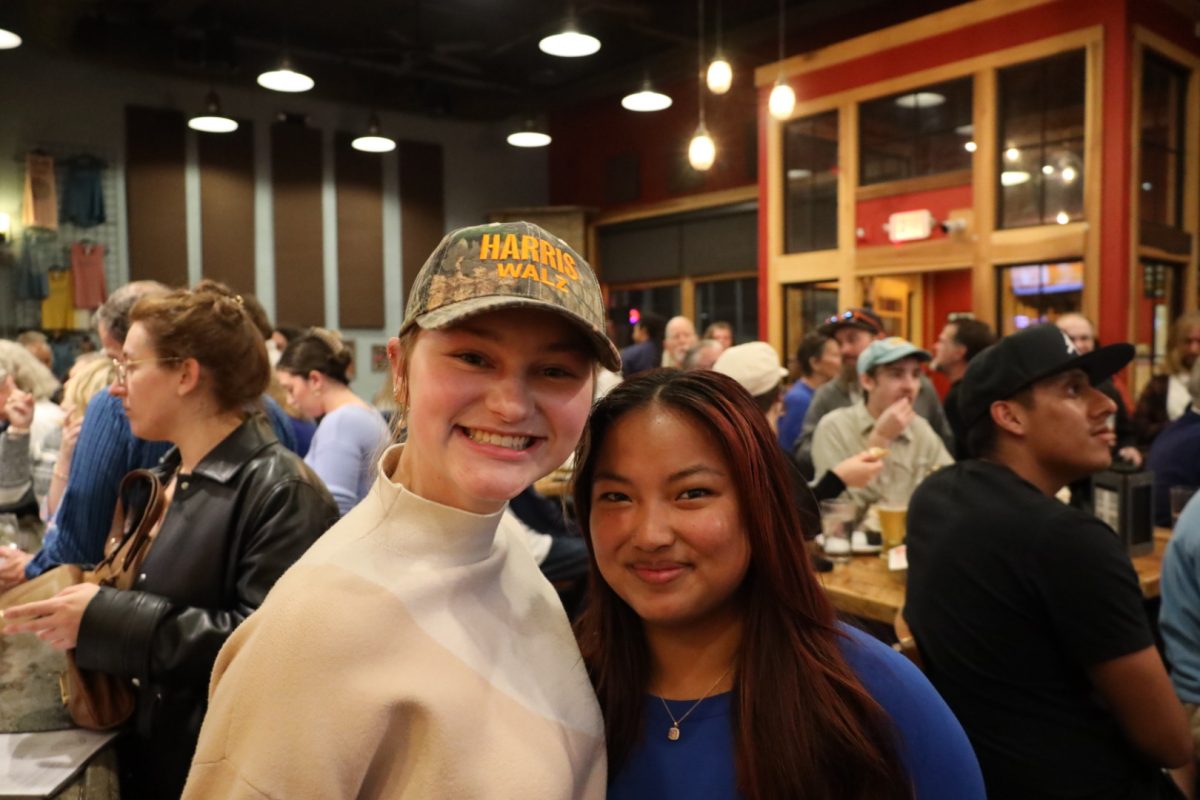 Sophomores (left) Noelle Johnston and Genevieve Matlovsky shared their thoughts at an election watch event at Lost Province Brewing Co. on Nov. 5. Johnston expressed the importance of being around people with similar views, stating, “I’m here to be around people who have similar views and no matter what, we all come together.”