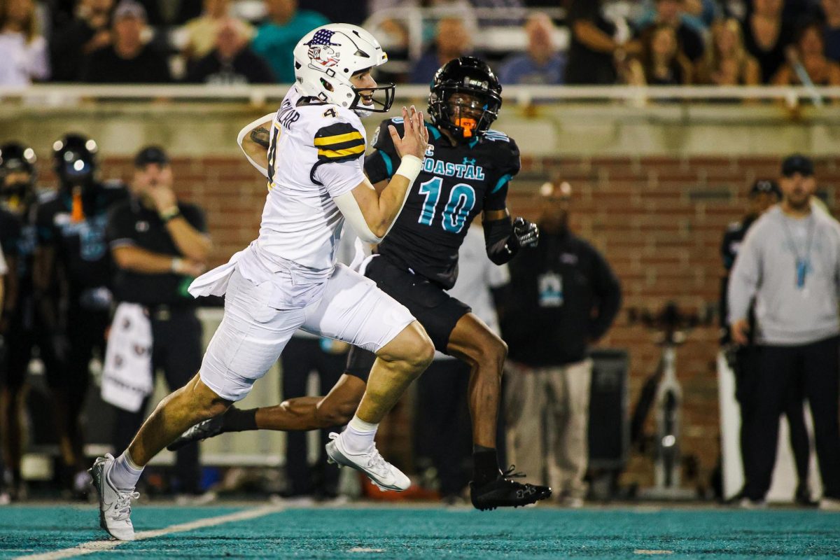 Quarterback Joey Aguilar runs downfield with the ball against Coastal Carolina on Nov. 7. Aguilar made 17 complete passes against Coastal Carolina.