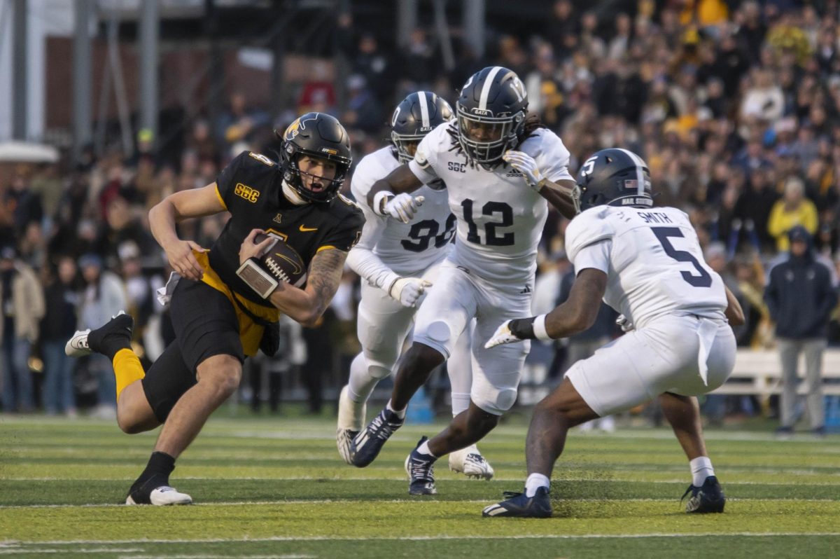 Quarterback Joey Aguilar carries the ball past three Georgia Southern players on Nov. 25, 2023.