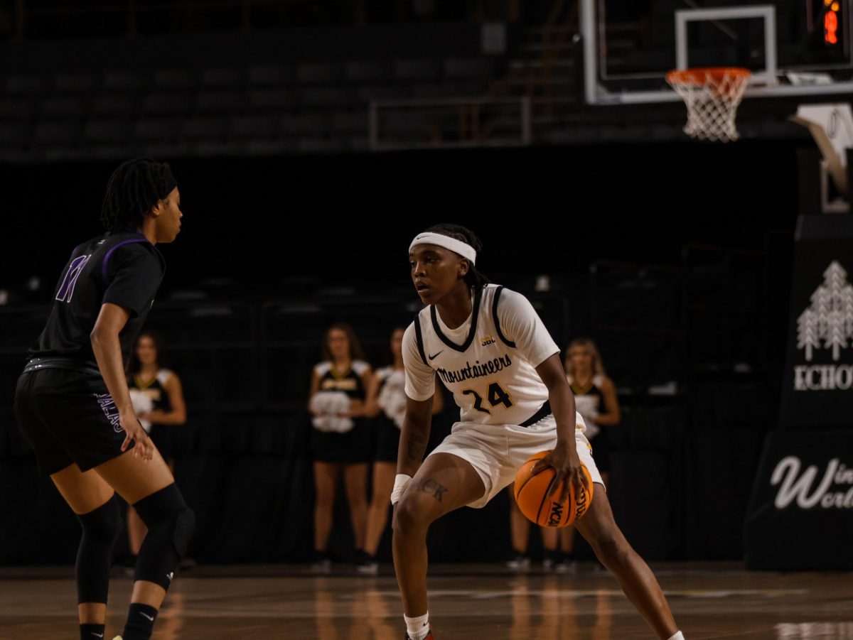 Senior guard Asjah Inniss brings the ball down the court against Columbia College on Nov. 6. The Mountaineers defeated Columbia 97-43.