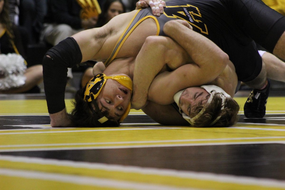 Redshirt freshman 184-pound Logan Eller tussles with West Virginia’s Dennis Robin at Varsity Gym on Nov. 22.