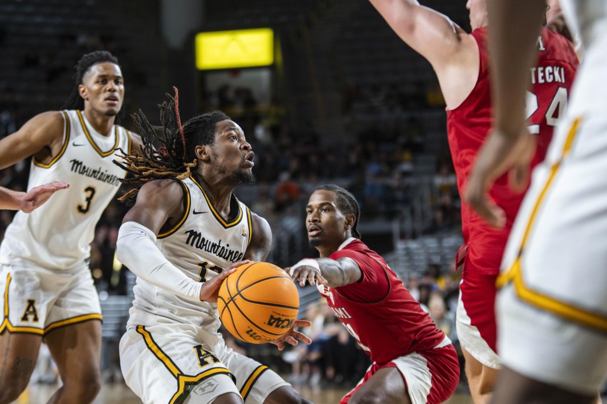 Redshirt senior Myles Tate makes a no-look pass into the paint at Holmes Convocation Center on Nov. 4. Following last season’s success, Tate aims to lead the Mountaineers to another Sun Belt championship.