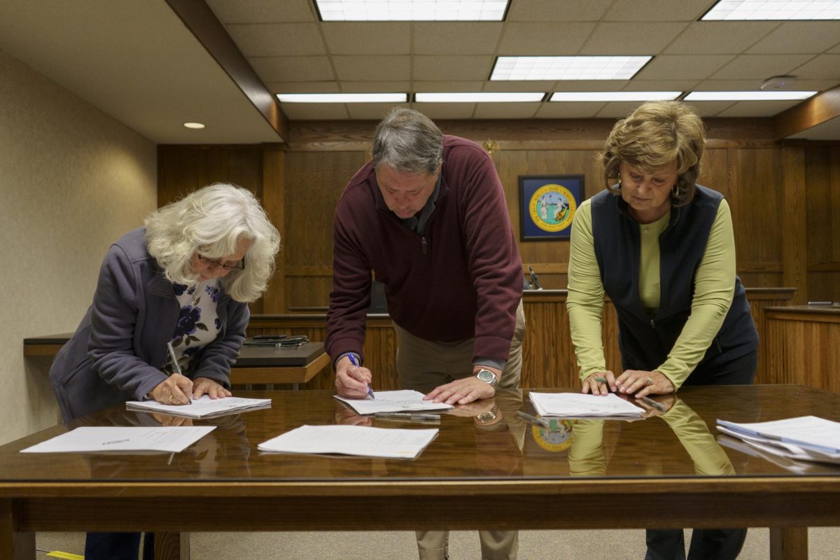 From left, Elaine Rothenberg, Eric Eller and Leta Councill gather at the Watauga County Courthouse on Nov. 15 to sign the unofficial “2024 General Election, Abstract of Votes.”