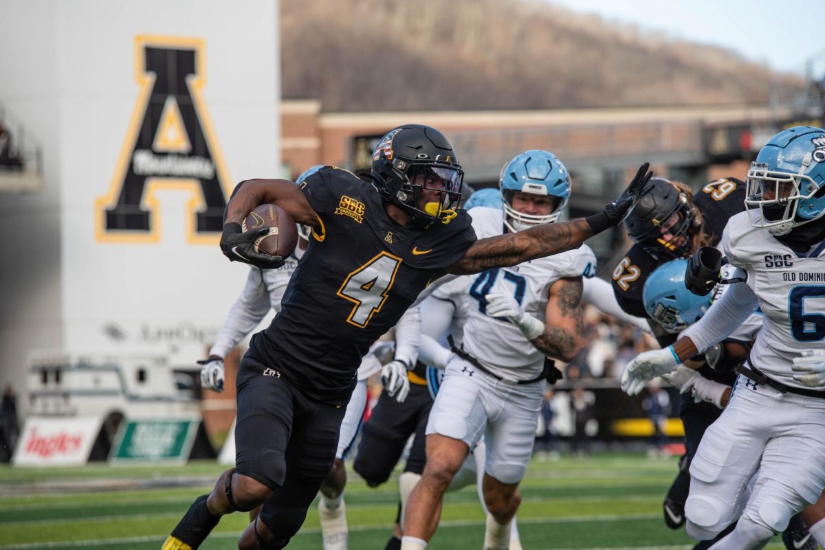 Running back Daetrich Harrington dodged Old Dominion players at the App State vs. Old Dominion game on Nov. 19, 2022.