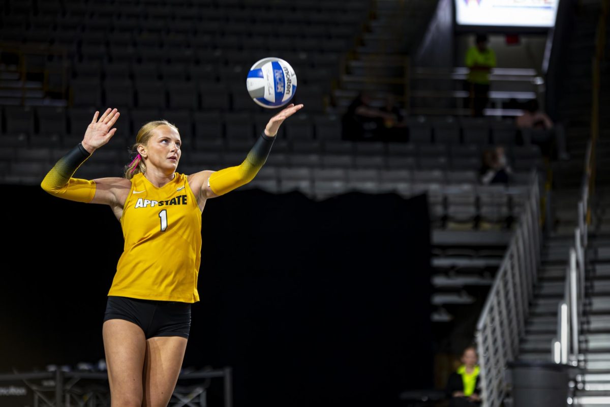 Outside hitter Lulu Ambrose aims to deliver a spike to Coastal Carolina on Oct. 24.