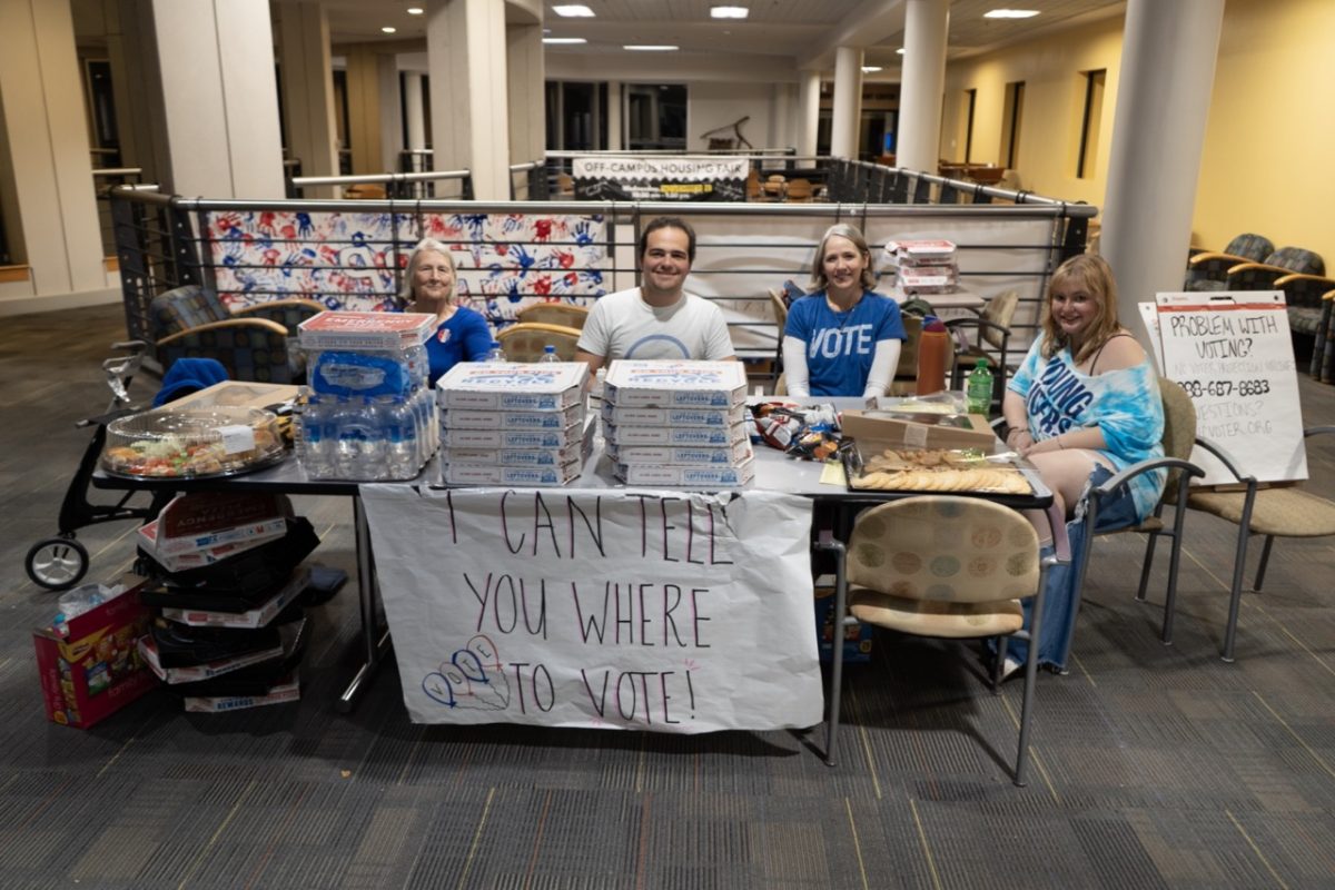 From right, Emily Pearl, Laurie Perryman, Juan Osete and Chris Behrend provide snacks and drinks to voters in line at Plemmons Student Union on Nov. 5.