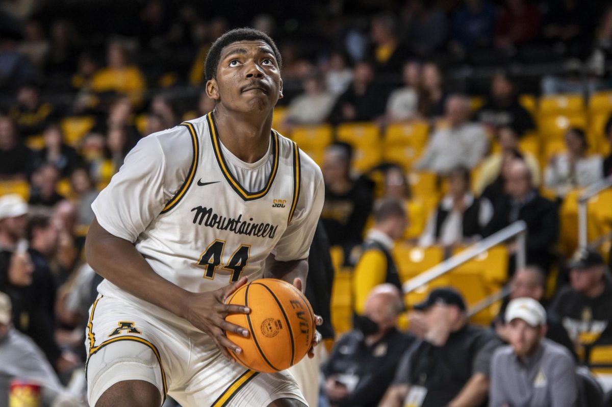 Forward Michael Marcus Jr. looks up to the hoop before taking a shot against Queens University on Nov. 19.