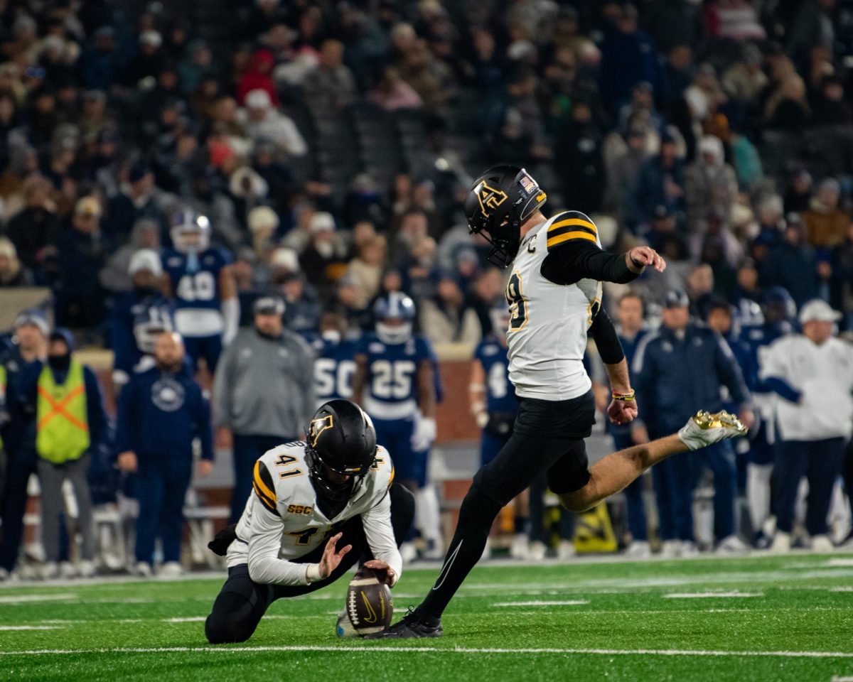 Kicker Michael Hughes kicks for an extra point after the Mountaineers scored a touchdown against Georgia Southern on Nov. 30.