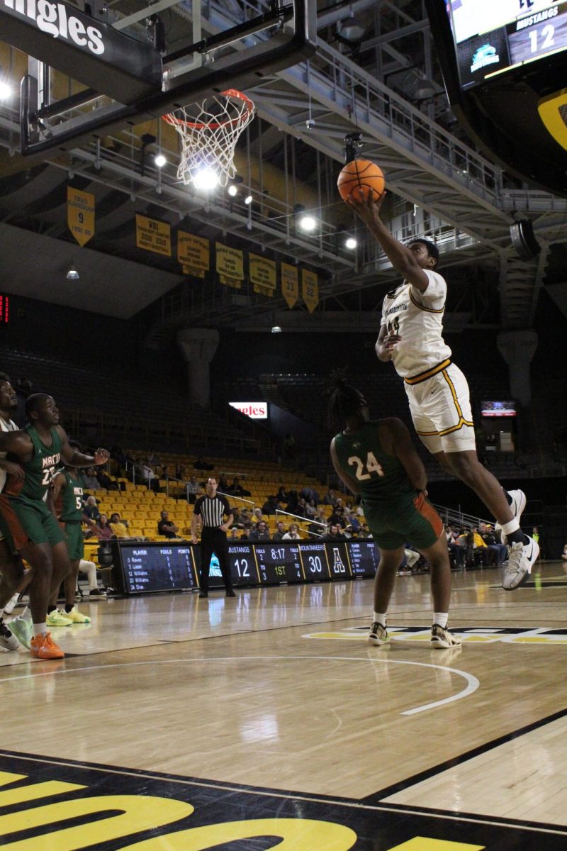 App State forward Michael Marcus Jr. leaps over Mid-Atlantic Christian’s forward Elijah Davis for a layup at Holmes Convocation Center on Dec. 3. 