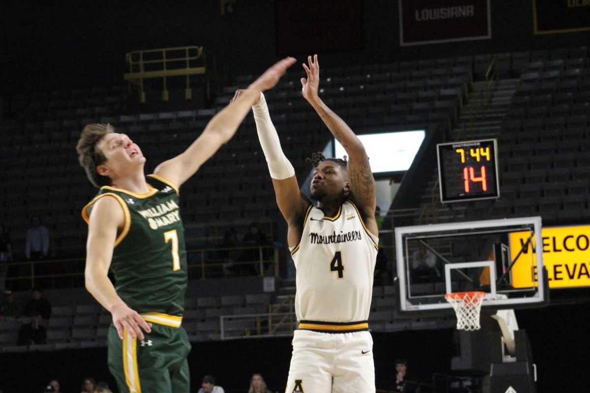 Guard Dior Conners making a shot against a William and Mary player on Nov. 24.