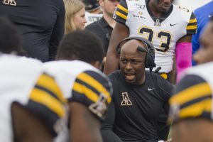 DJ Smith in a huddle with App State players during their game against Charlotte on Sept. 21, 2019.