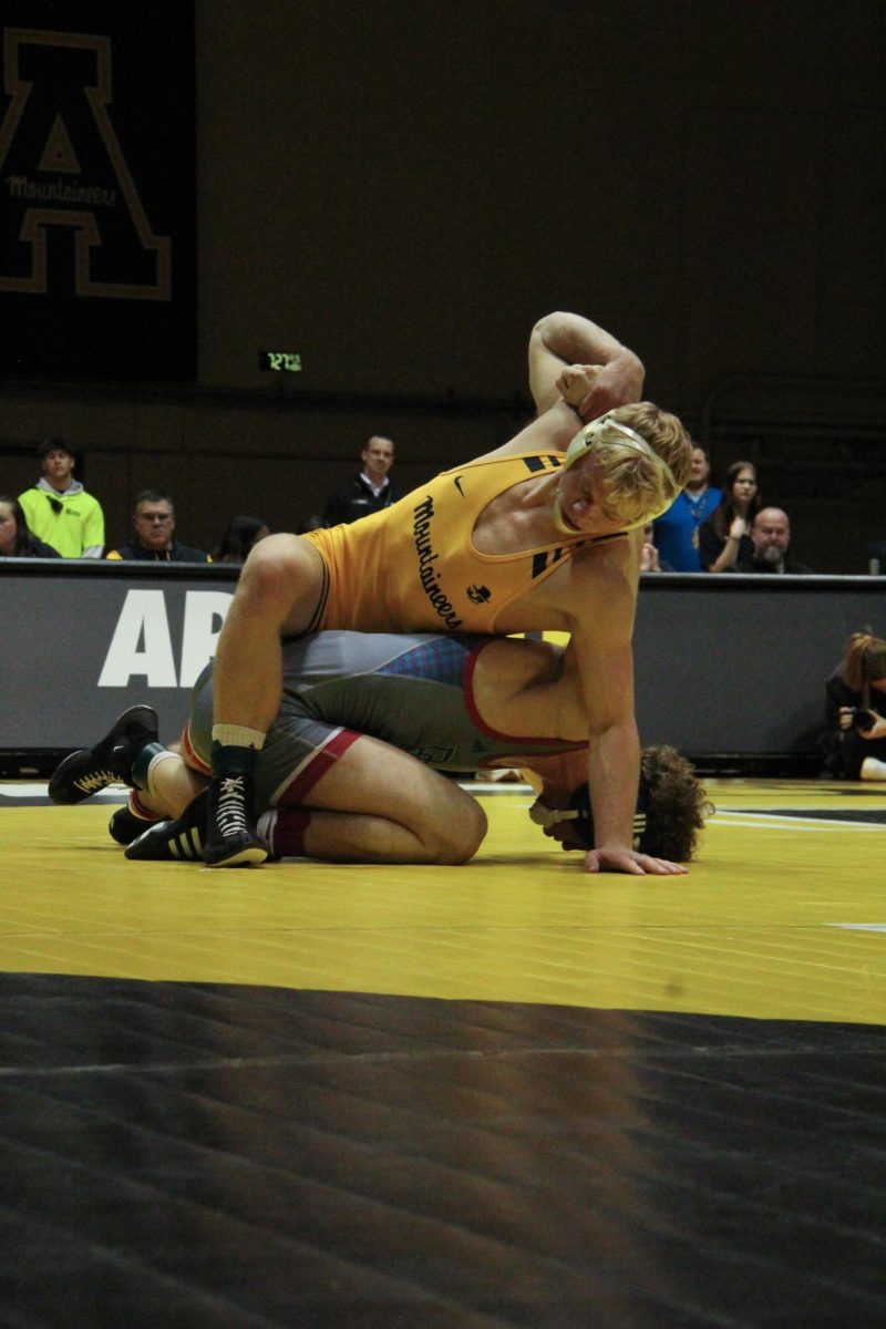 Senior 165-pound Will Miller performs a guillotine on Presbyterian's Joshua Roe on Jan. 27. Miller is currently ranked No. 7 in the country for his weight class with a record of 10-1.