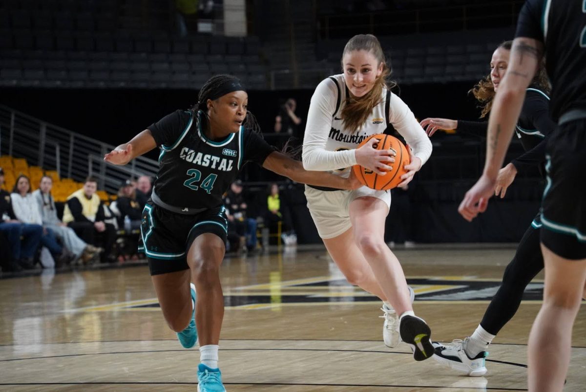 Junior guard Emily Hege drives through the lane in search of points for the Mountaineers against Coastal Carolina on Jan. 11.