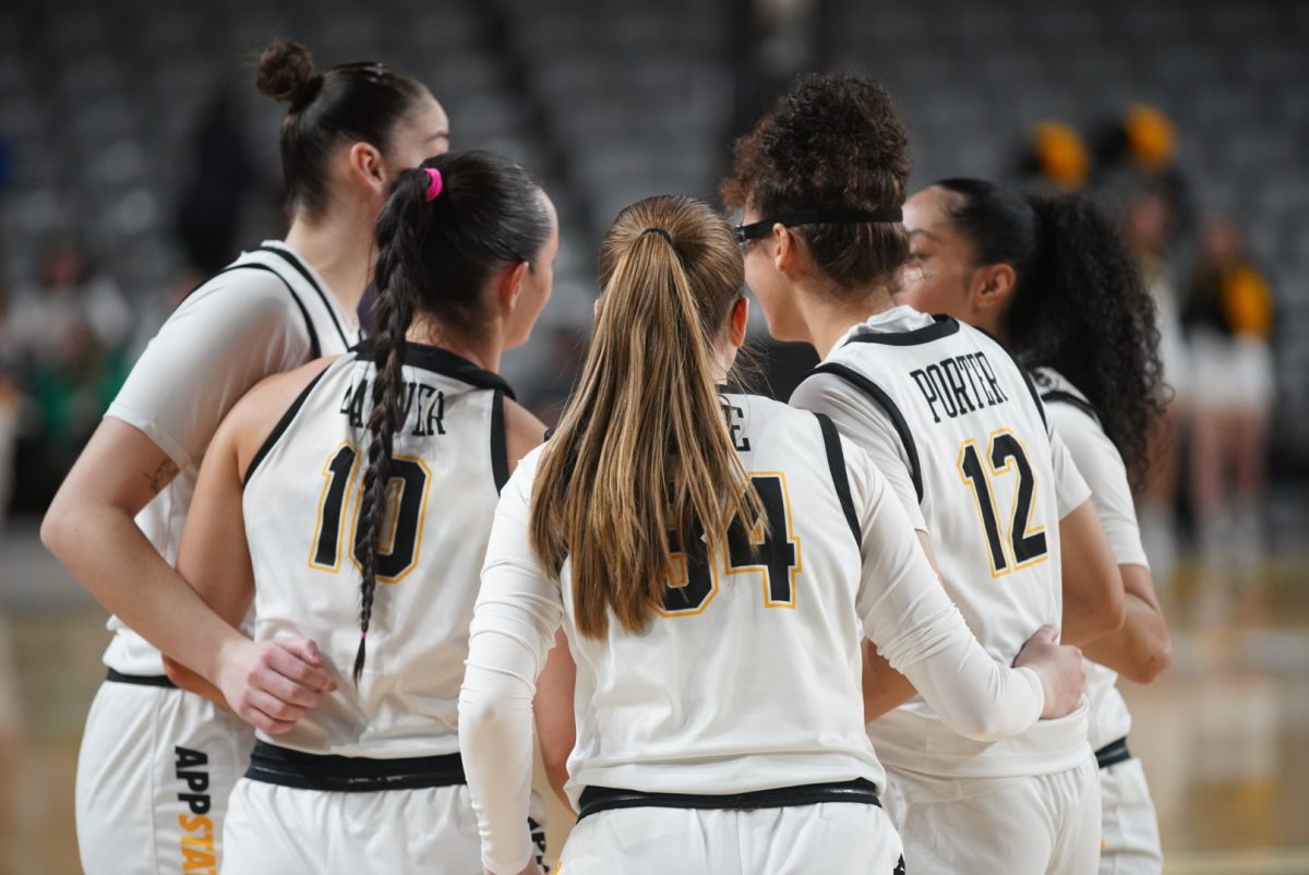 The Mountaineers huddle together for a timeout during the game against Arkansas State on Dec. 29.