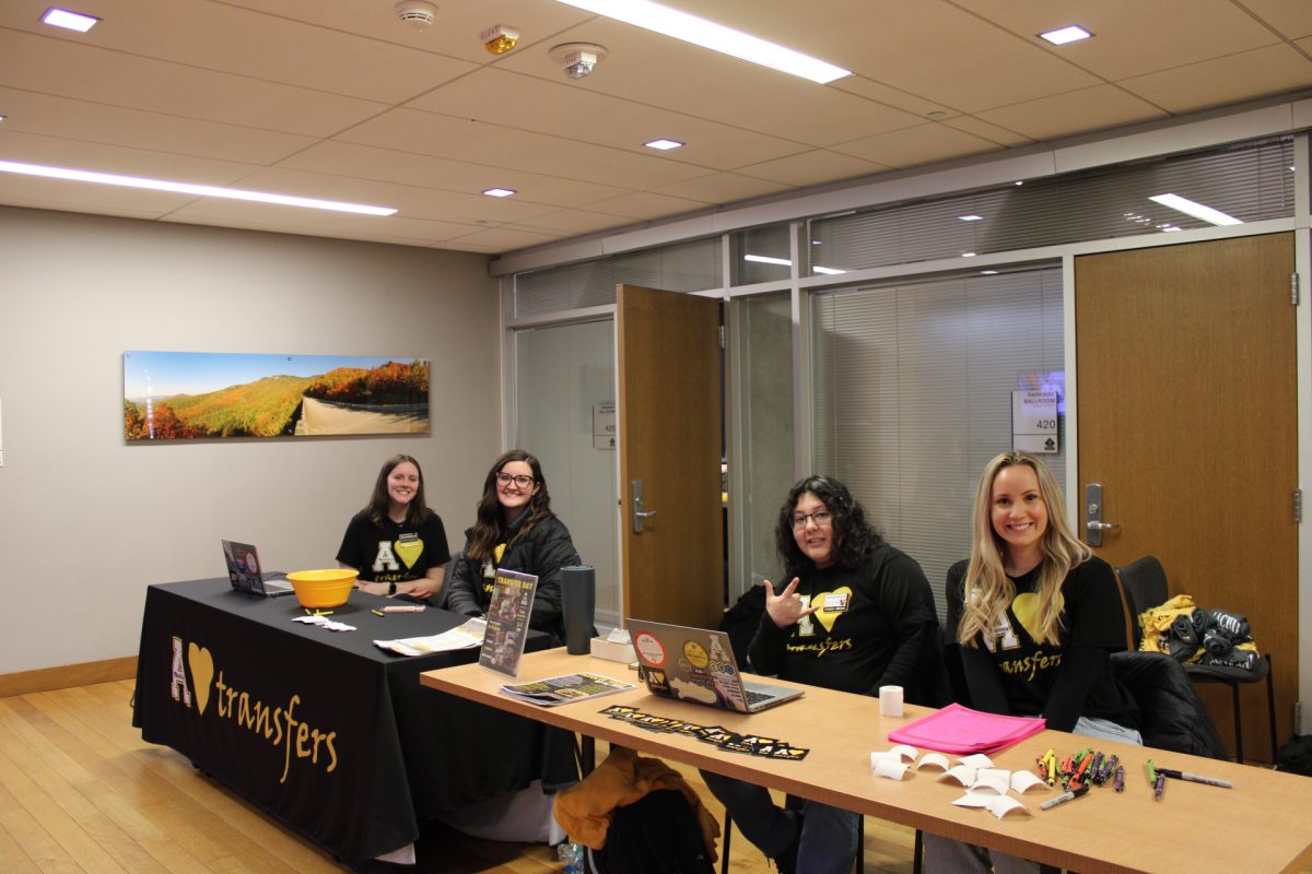 From left, Cara Tomberlin, Gracelyn Anderson, Yairis Gameros-Escobedo and Lauren Broadway manage the check-in desk at the transfer welcome back pizza party on Jan. 15.