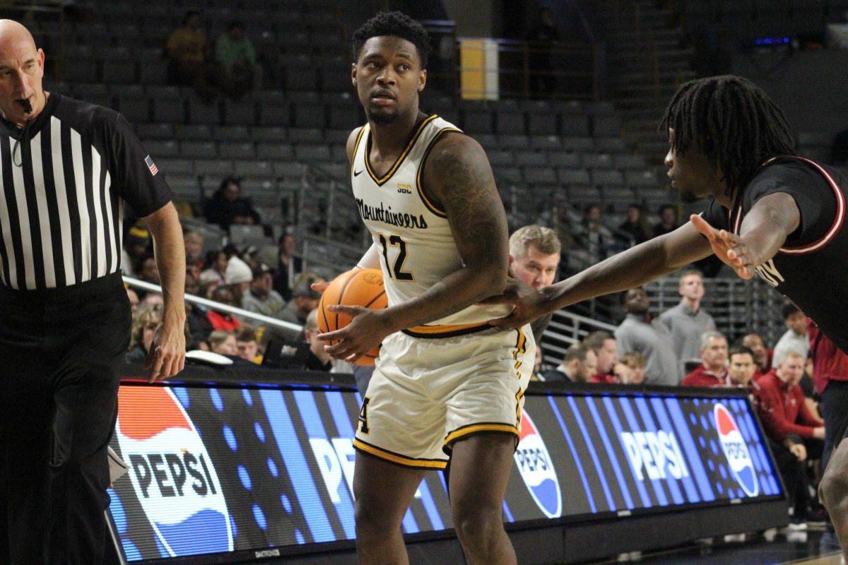 Redshirt senior guard Myles Tate examines the defense of Troy during the App State vs. Troy game on Jan. 2. Tate led App State in scoring with 20 points during the game.