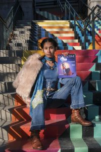 Jaidyn Toomey holds the 7th issue of “The Collective” from Spring 2024 while sitting on the Turchin Center for the Visual Arts stairs on Jan. 17. Toomey helped to organize the cover shoot of “The Collective” Spring 2024 issue. Ashton Woodruff