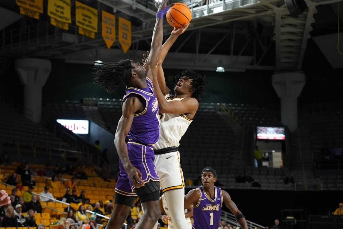 Graduate student forward CJ Huntley attempts a shot against James Madison on Jan. 11.