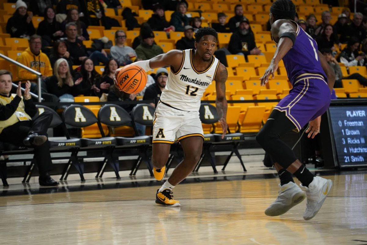 Redshirt senior guard Myles Tate attempts to move past the James Madison defense on Jan. 11.