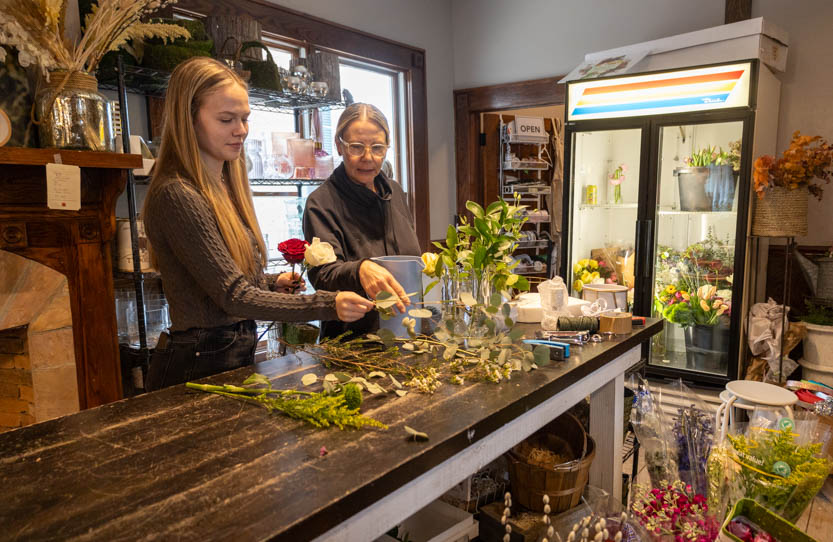 From left, King Street Flowers & Gifts employee Bella Porter and owner Fuschia Moss assemble a bouquet on Jan. 30.