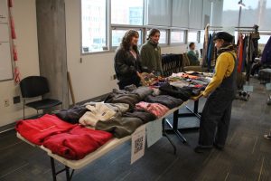 From left, Dezirae Britton and Sam Cullen assist a shopper with items available at their table in Plemmons Student Union on Feb. 19. 