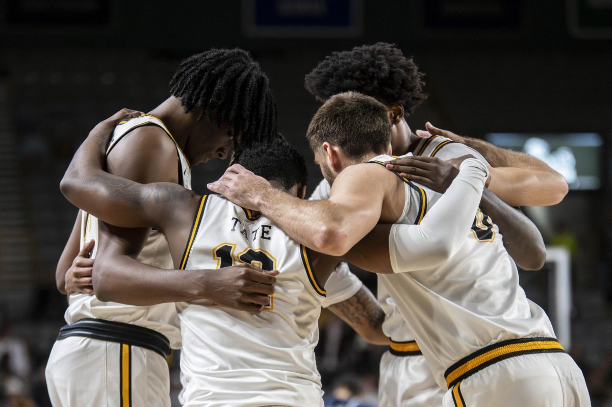 From left, men’s basketball players CJ Huntley, Myles Tate, Jackson Threadgill, Jalil Beaubrun and Dior Conners huddle up before the App State vs. Queens game on Nov. 19. 