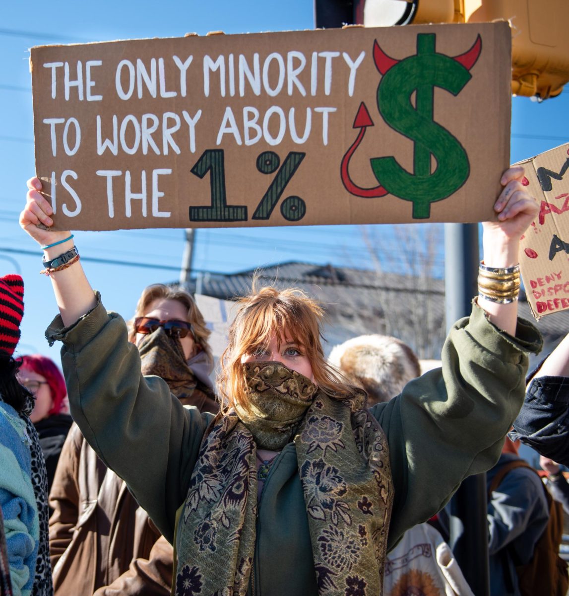 An App State student holds a sign that reads “THE ONLY MINORITY TO WORRY ABOUT IS THE 1%” during protests on Feb. 17.