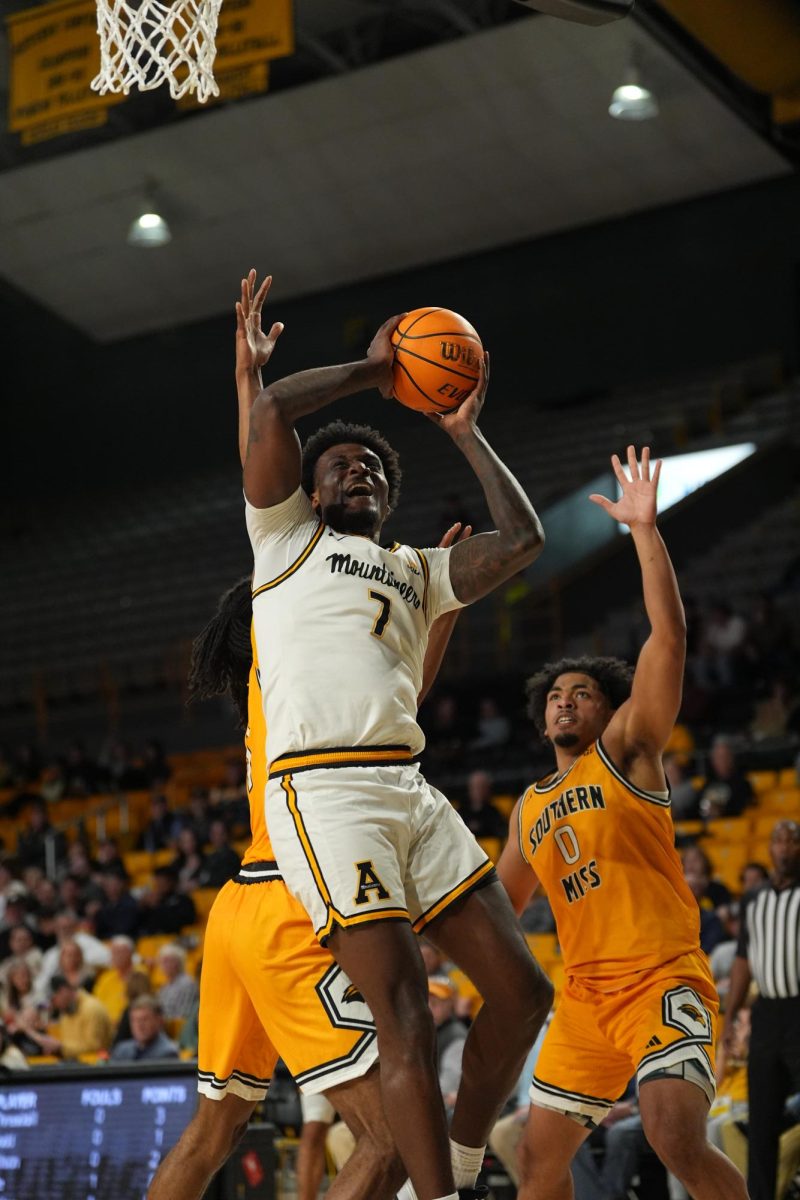 Senior forward Jalil Beaubrun leaps for the shot against Southern Miss players on Feb. 5.