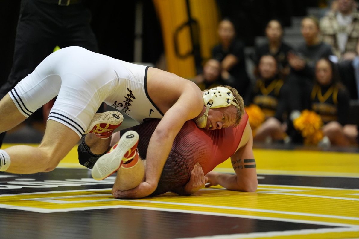 Senior 165-pound Will Miller gains a 3-point takedown against his opponent on Feb. 16. 