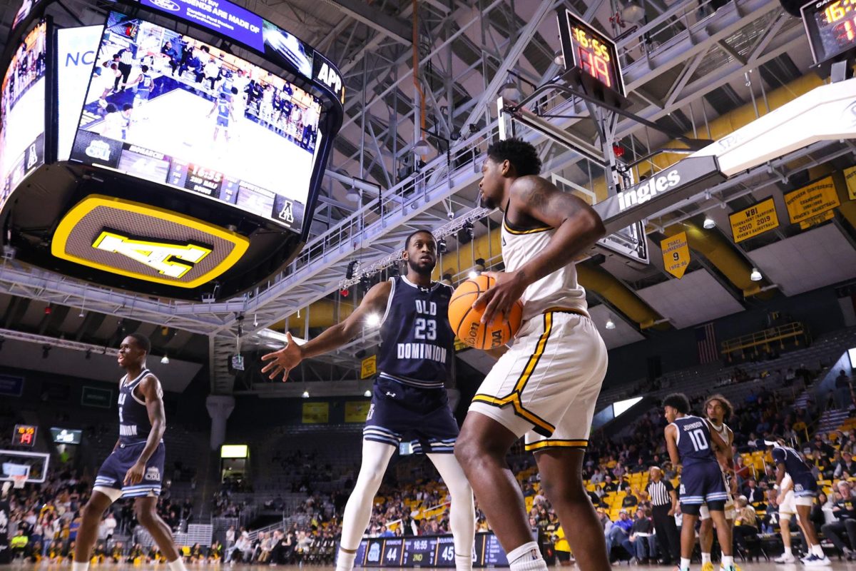 Senior guard Myles Tate looks for a pass against ODU at the Holmes Convocation Center on Jan. 29. Tate led the Mountaineers with a total of 120 assists in the 2024 season.