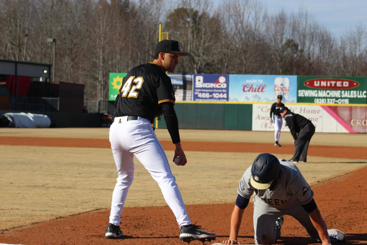 Senior first baseman Juan Correa stares down a Queens University base runner after a pickoff attempt at LP Frans Stadium on Feb. 14.