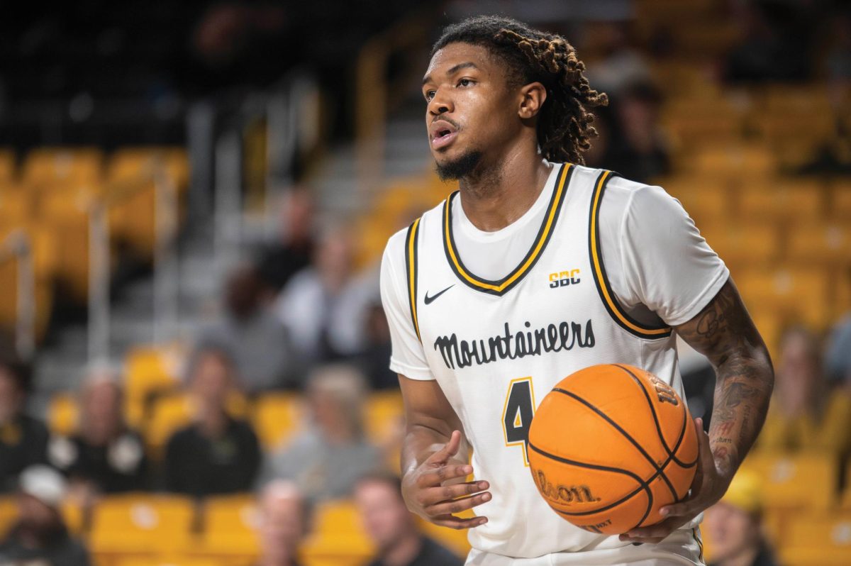 Junior guard Dior Conners runs the ball down the court during the App State vs. Queens University game on Nov. 19.