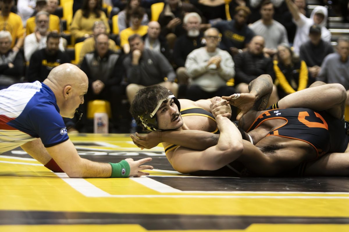 Redshirt junior 174-pound Luke Uliano holds his Campbell opponent down at the match on Feb. 23. Uliano won his match, helping App State gain points against Campbell.