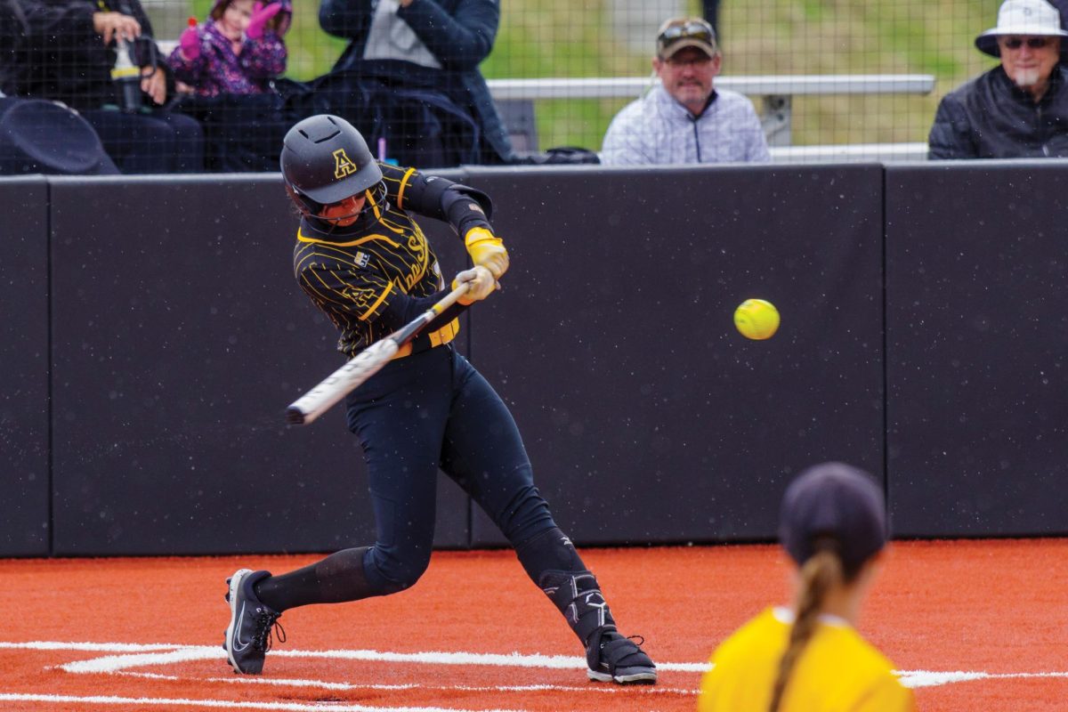 Freshman catcher Leah Gore swings at a pitch during the App State vs. ULM game on April 13.
