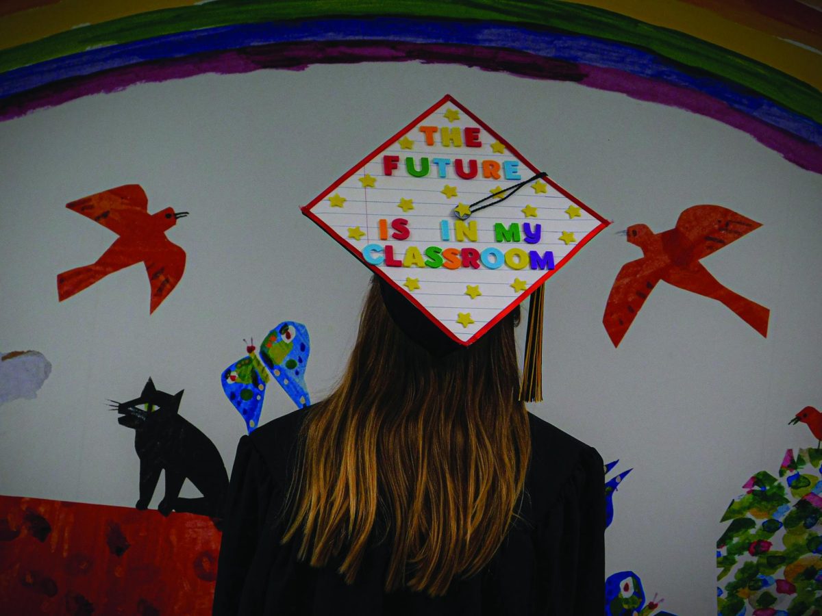Senior middle grades education major Emily Horvath wears her decorated graduation cap, which is themed around education.
