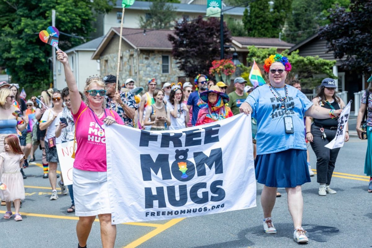Emily Beach (left) and associate represent Free Mom Hugs on June 28. The organization has chapters in all 50 states.