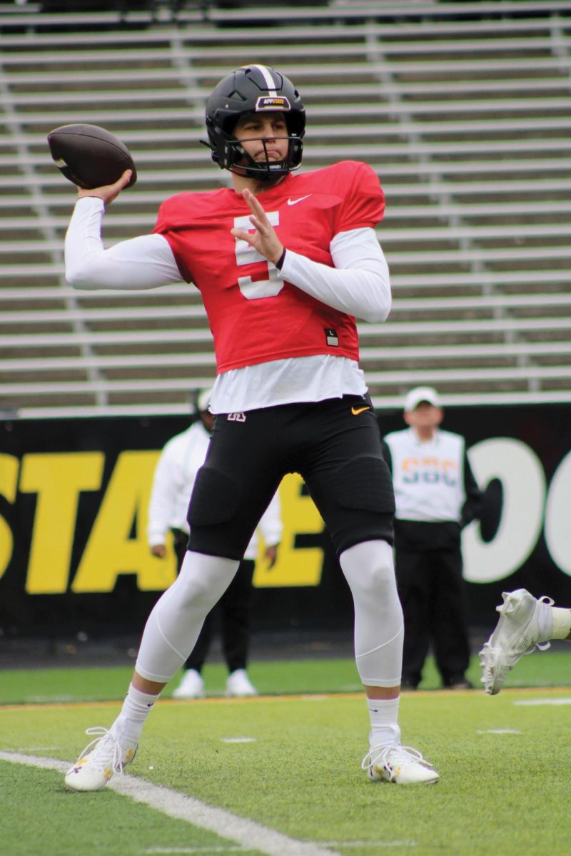 Redshirt junior quarterback AJ Swann winds up for a pass during the Spring Battle at the Rock game on April 12.
