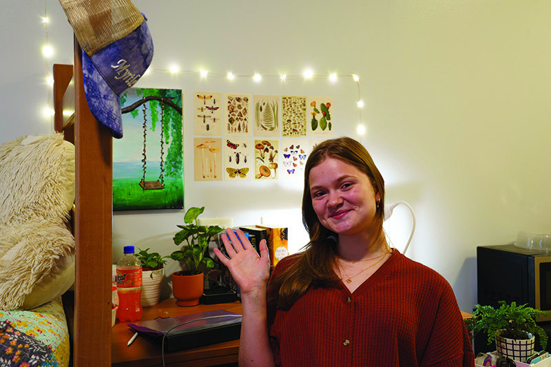 Sophomore psychology major Lillian Wood waves in front of her desk in Thunder Hill Hall on Aug. 19. 