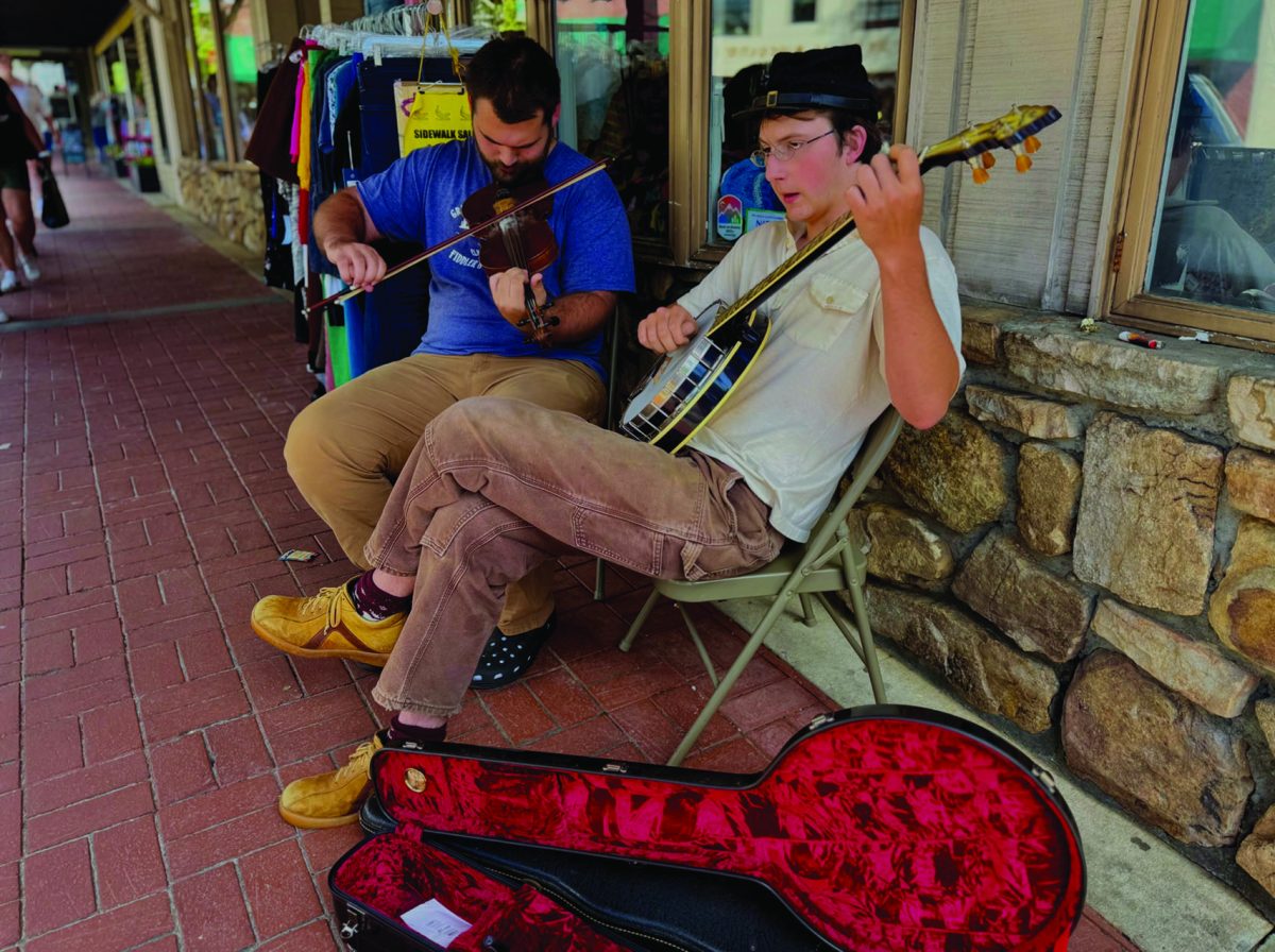 Two musicians playing during Boonerang at the entrance of Anna Banana's on King Street in downtown Boone on June 20.