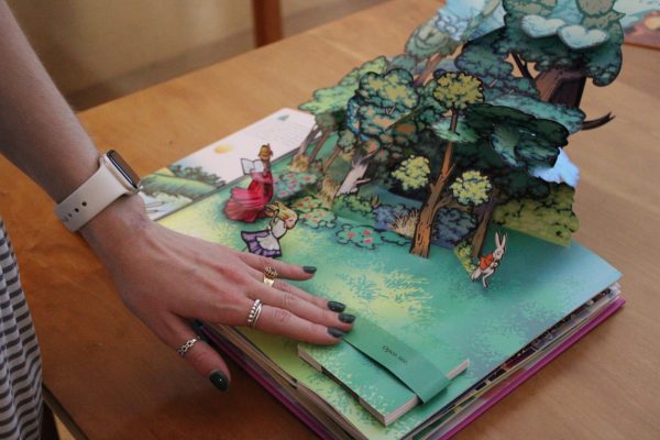 Freshman biology major Ella Black looks through pop-up books, some even made from students at App State.