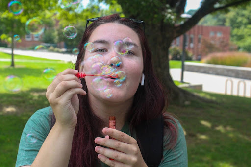 Freshman political science major Bella Surber blows bubbles at AppalFest, Sept. 5.