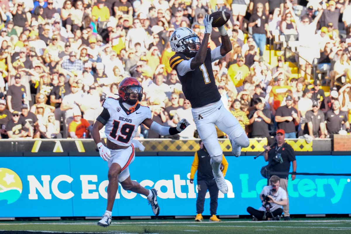 App State redshirt sophomore wide receiver Davion Dozier makes a catch in the endzone for a touchdown against Oregon State freshman defensive back Trey Glasper at Kidd Brewer Stadium on Oct. 4. 
