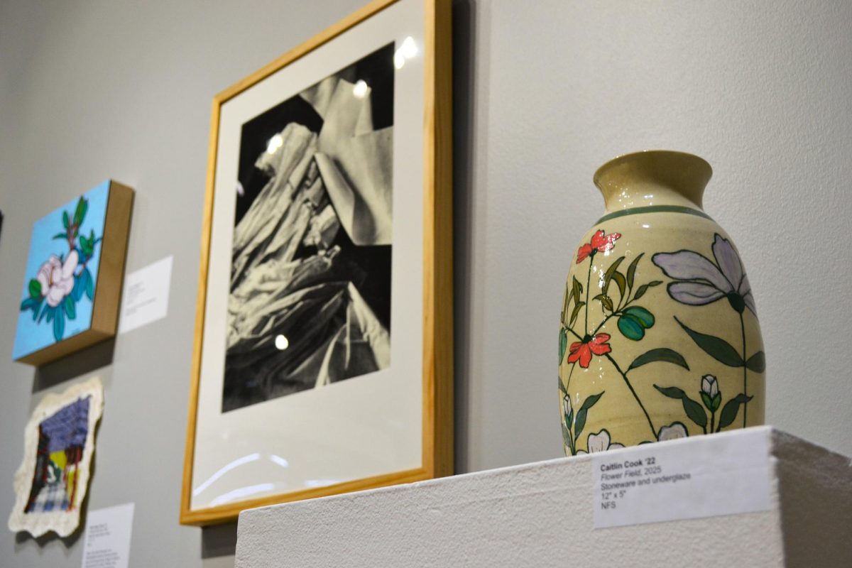 A sculpted vase and paintings on display in App State’s Alumni Exhibition in Wey Hall on Sept. 30. The vase is made by Caitlin Cook, a 2022 alumna, who currently works as a studio assistant at Anderson Ranch Arts Center. 