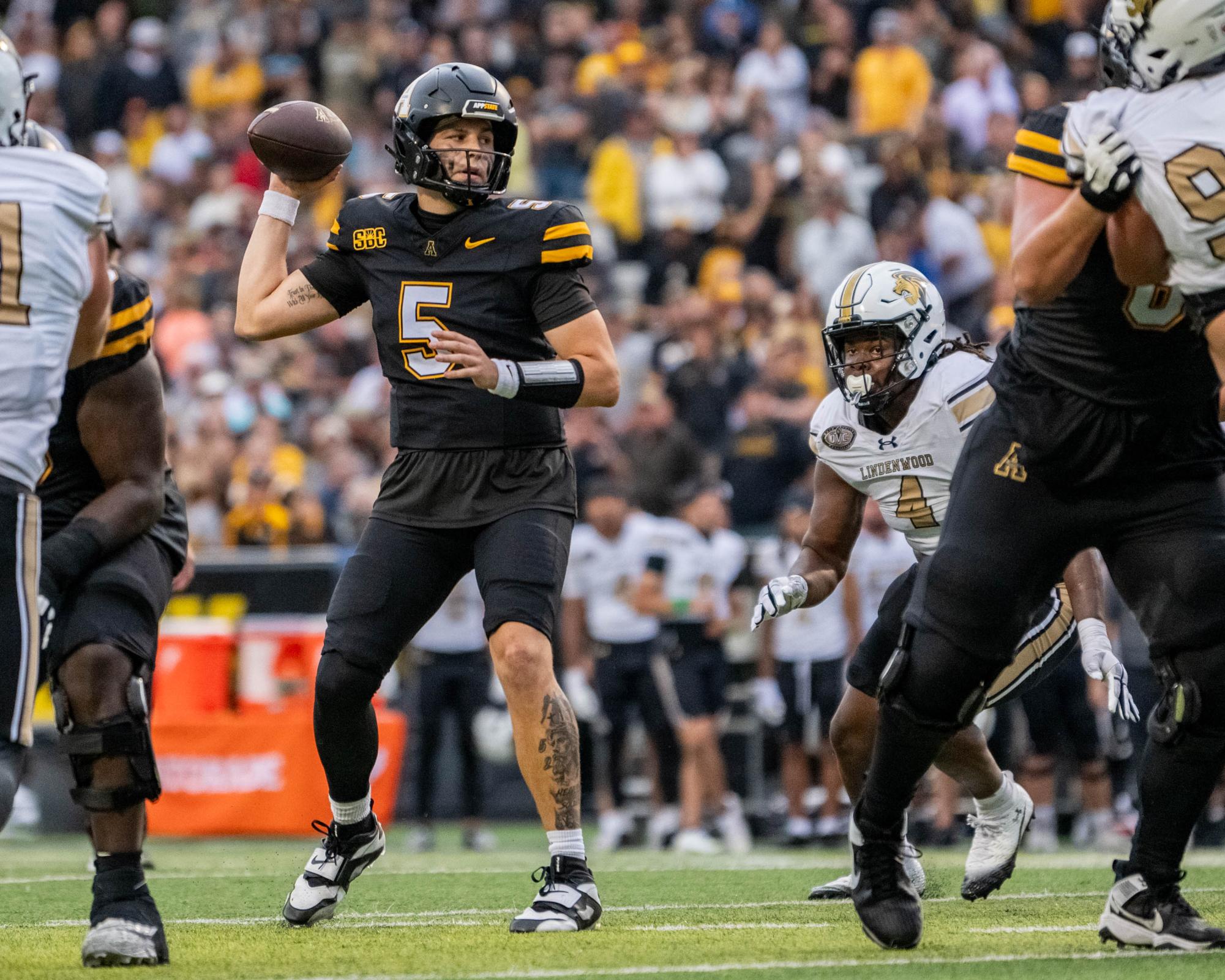 Redshirt junior quarterback AJ Swann passes the ball to a teammate in a game against Lindenwood on Sept. 6 at Kidd Brewer Stadium. 