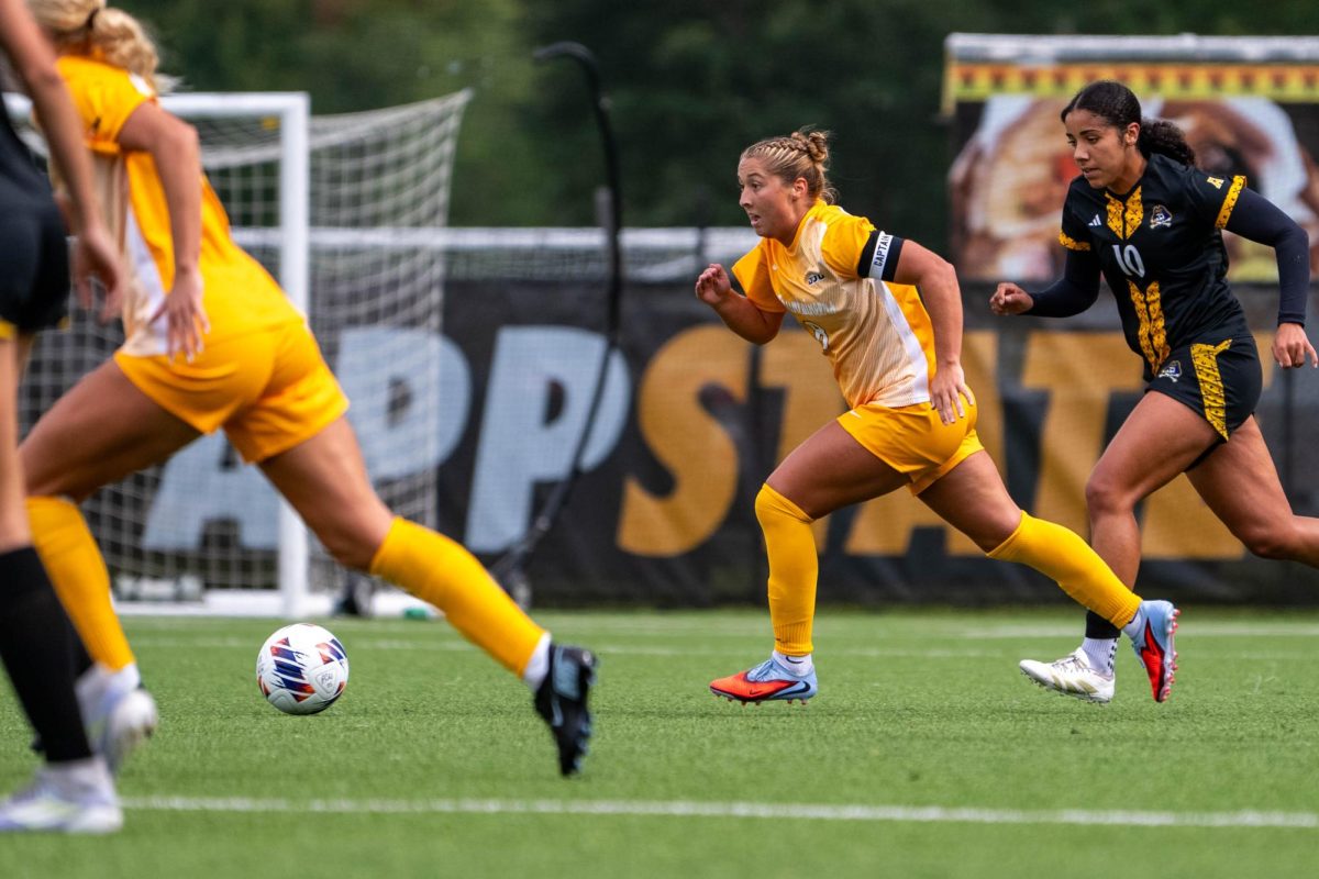 Senior defender Shannon Studer dribbles the ball down the field during the first half of the game against ECU at Ted Mackorell Soccer Complex on Aug. 4.

