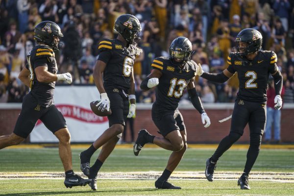 App State celebrates a play from redshirt junior defensive back Emory Floyd at Kidd Brewer Stadium during a game against Marshall University on Nov. 22.