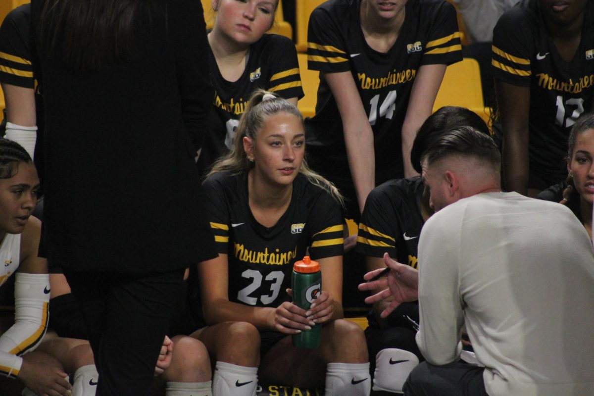 Redshirt sophomore right side hitter Delanie Grevengoed listening to head volleyball coach Chad Sutton during the App State vs. Troy match in Homes Convocation Center on Nov. 14. 