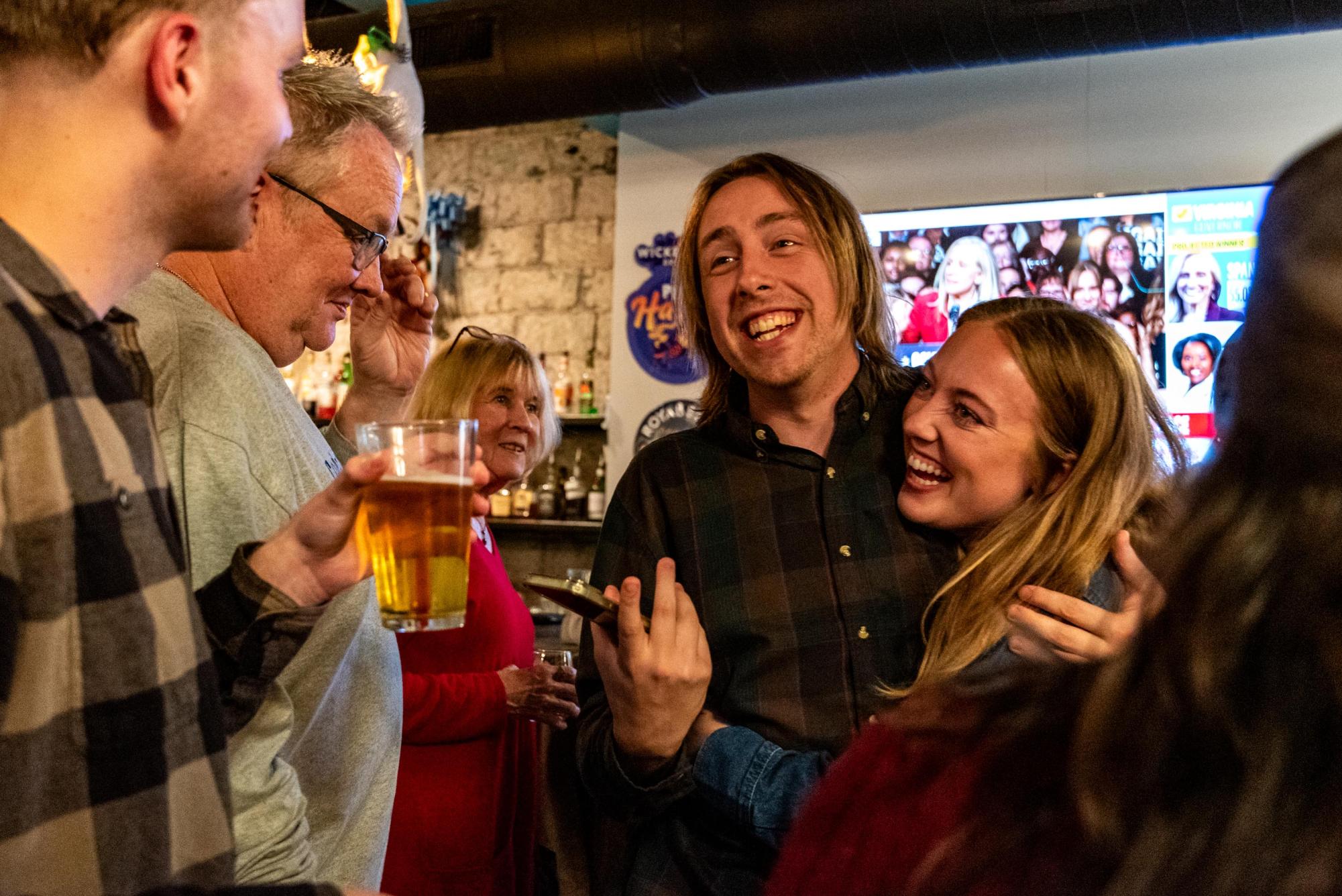 Mayoral candidate Dalton George, center, and his partner Sophie Mead, right, celebrate favorable polling predictions at FizzEd on Nov. 4.
