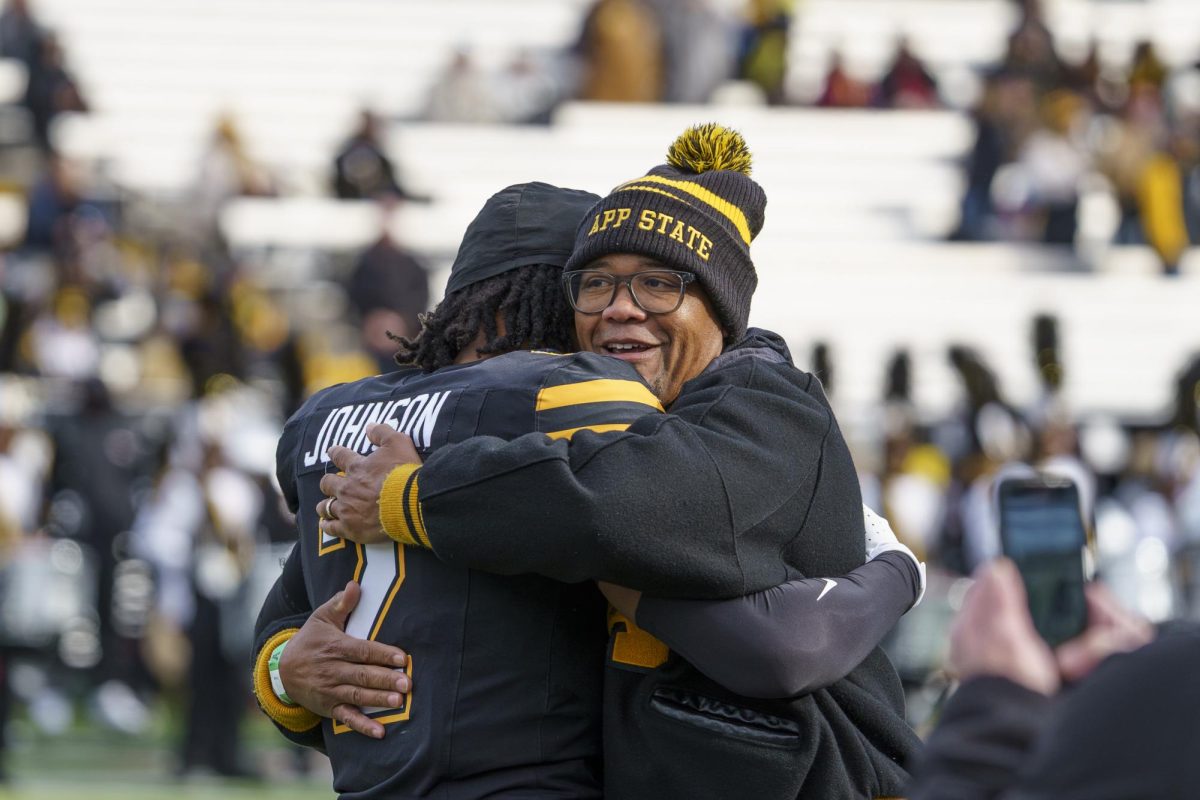A family celebrates an App State senior at the last game of the season against Arkansas State at Kidd Brewer Stadium on Nov. 29.

