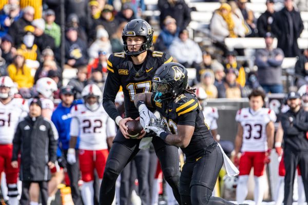 Redshirt sophomore quarterback JJ Kohl hands off the ball to freshman running back Jaquari Lewis at Kidd Brewer Stadium on Nov. 29. 
